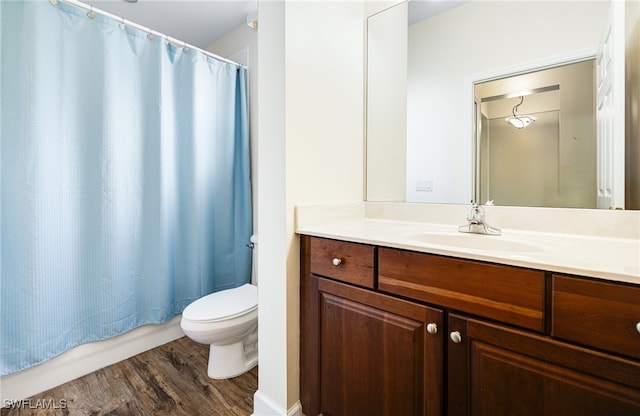 bathroom featuring vanity, shower / tub combo, wood finished floors, and toilet