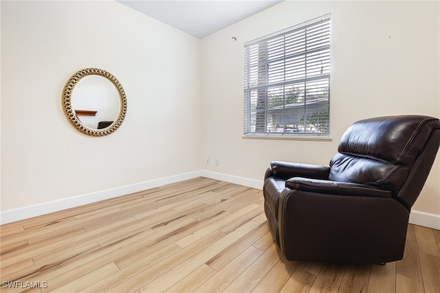 living area with light wood-style floors and baseboards