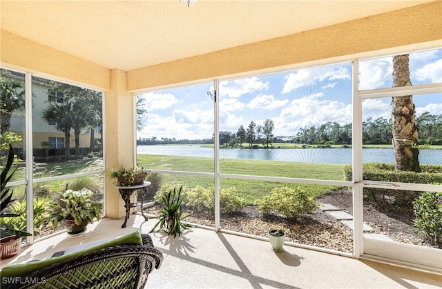 sunroom featuring a water view and a wealth of natural light