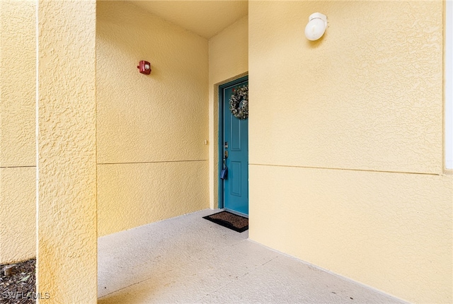 doorway to property with stucco siding