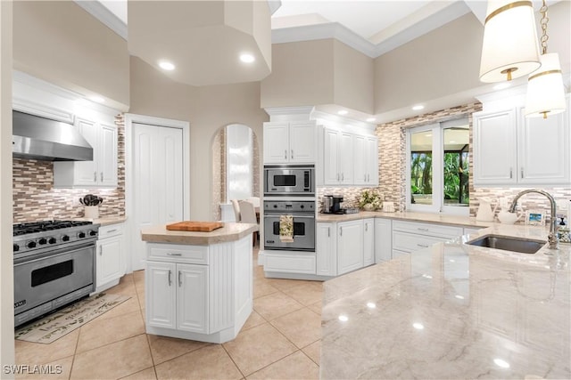 kitchen with white cabinets, sink, wall chimney exhaust hood, appliances with stainless steel finishes, and light stone counters