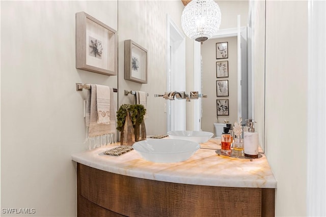 bathroom with vanity and a notable chandelier