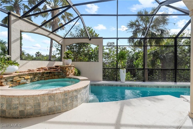 view of pool with an in ground hot tub and glass enclosure