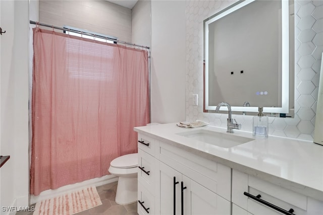 full bathroom featuring tasteful backsplash, tile patterned flooring, toilet, shower / bath combo with shower curtain, and vanity