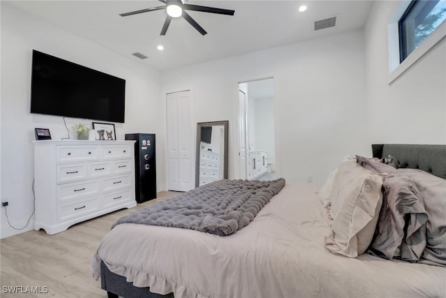 bedroom with light hardwood / wood-style flooring and ceiling fan