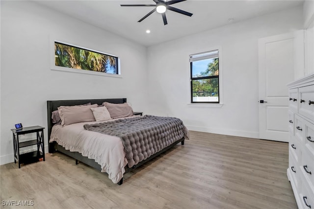 bedroom with ceiling fan and light hardwood / wood-style flooring