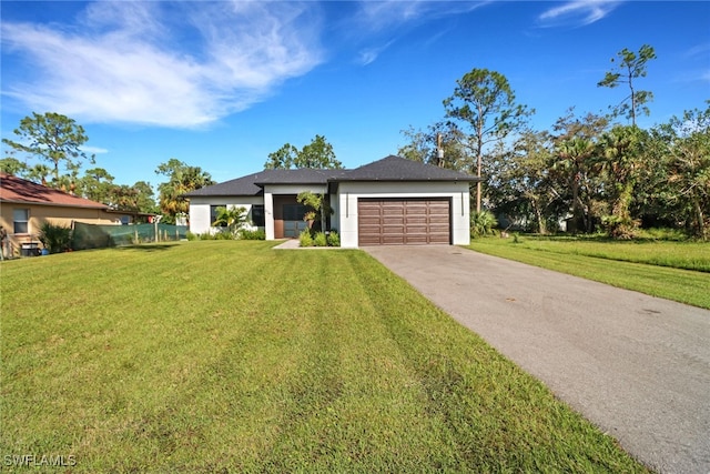 view of front of house featuring a garage and a front lawn