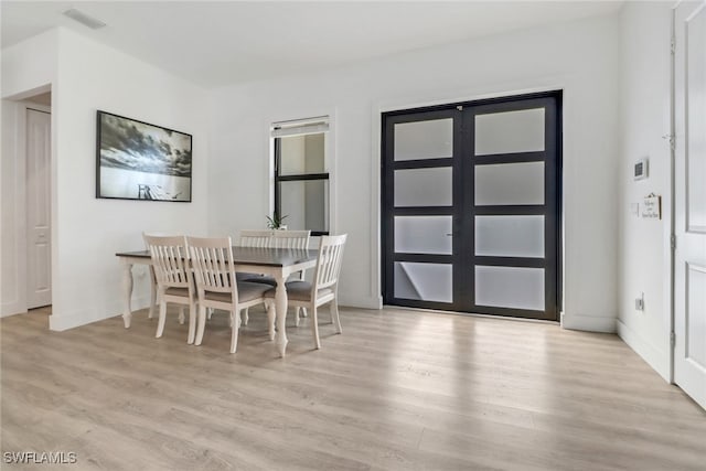 dining space with light hardwood / wood-style floors