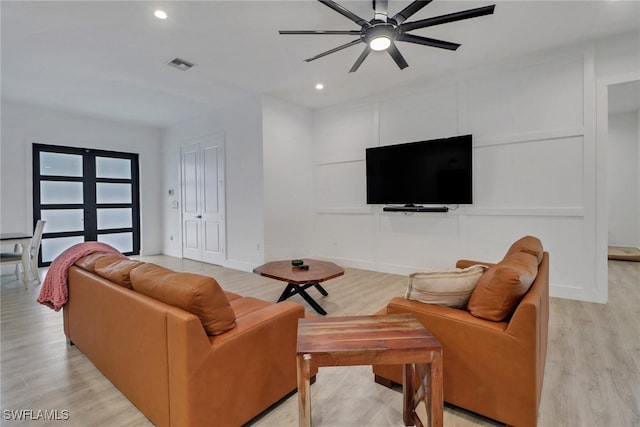 living room with ceiling fan and light wood-type flooring