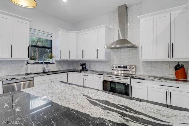 kitchen featuring white cabinetry, sink, wall chimney exhaust hood, decorative backsplash, and appliances with stainless steel finishes