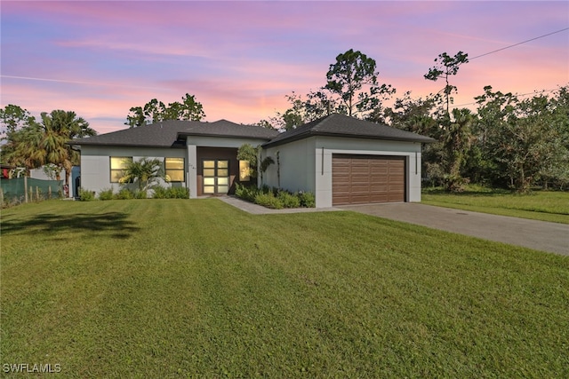 view of front facade featuring a lawn and a garage