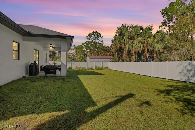 yard at dusk with ceiling fan