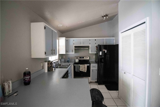 kitchen featuring stainless steel electric range oven, sink, black fridge, lofted ceiling, and light tile patterned flooring