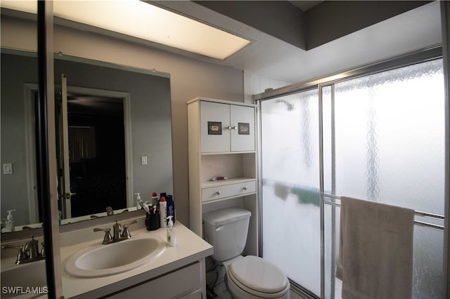 bathroom with vanity, toilet, and an enclosed shower