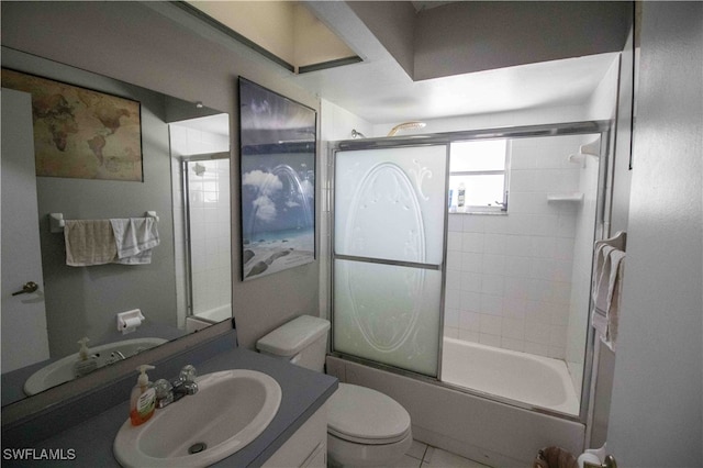 full bathroom featuring combined bath / shower with glass door, vanity, toilet, and tile patterned flooring