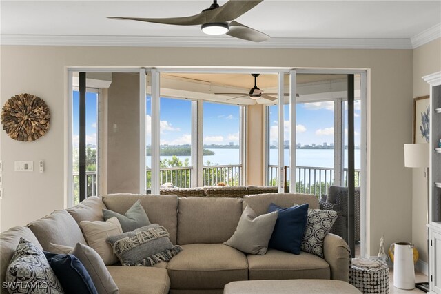 living room with a water view, ceiling fan, and ornamental molding