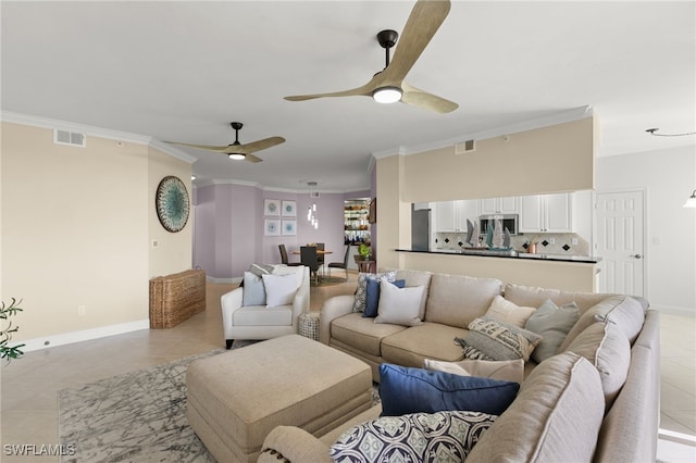 tiled living room with ceiling fan and crown molding