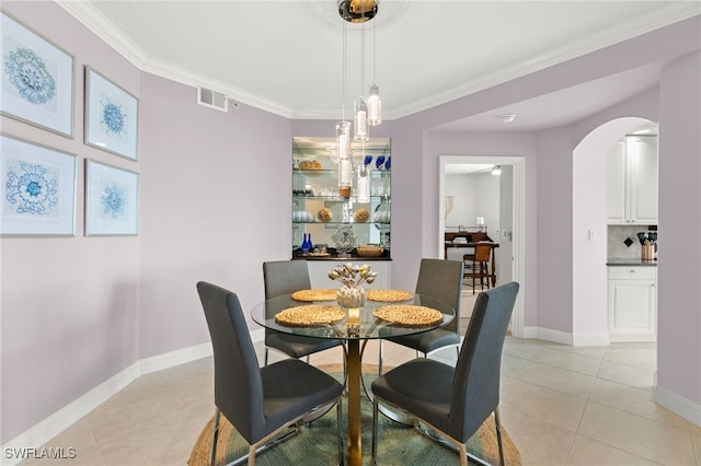 269 Vintage Bay Dr Unit C-13, Marco Island, FL 34145 - dining area with light tile patterned flooring, arched walkways, and ornamental molding