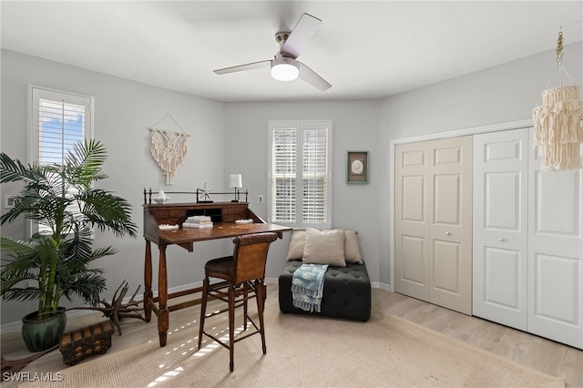 office area with ceiling fan, a healthy amount of sunlight, and light wood-type flooring