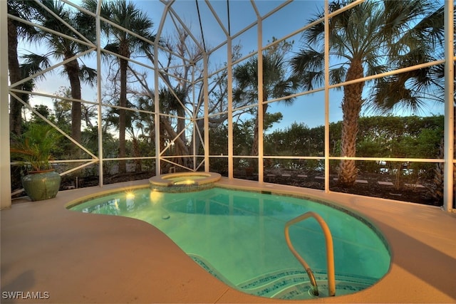 view of swimming pool featuring an in ground hot tub, a patio area, and a lanai