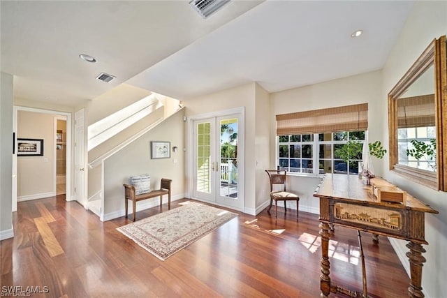 entrance foyer with hardwood / wood-style floors, a healthy amount of sunlight, and french doors