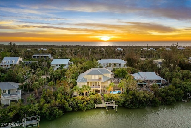 aerial view at dusk with a water view