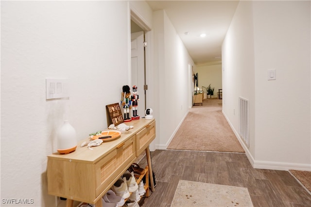 corridor with dark colored carpet