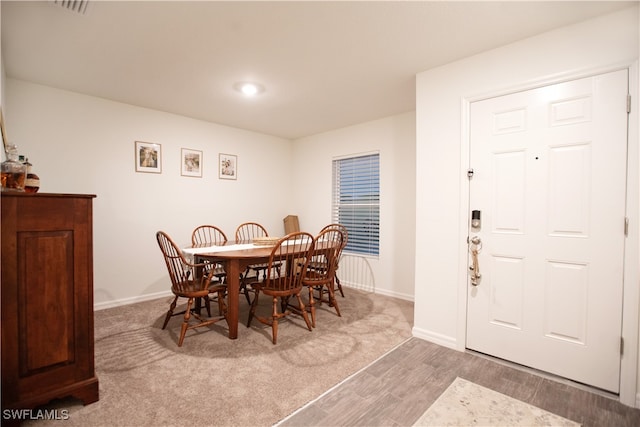 dining space with light hardwood / wood-style flooring