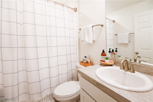 bathroom with vanity, toilet, and curtained shower