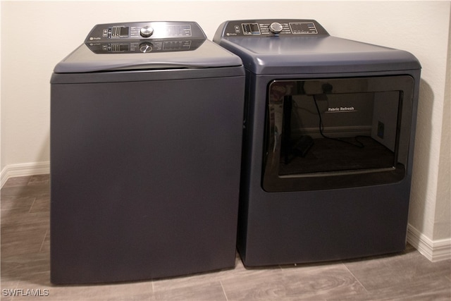 clothes washing area featuring tile patterned floors and separate washer and dryer