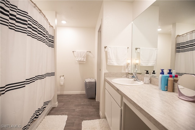 bathroom with vanity and hardwood / wood-style flooring