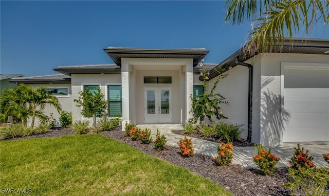 view of front facade featuring french doors, a garage, and a front lawn