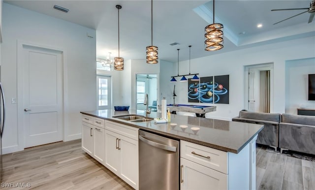 kitchen featuring stainless steel dishwasher, sink, pendant lighting, light hardwood / wood-style flooring, and white cabinets