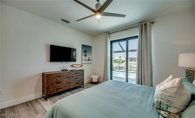 bedroom featuring ceiling fan, light wood-type flooring, and access to outside