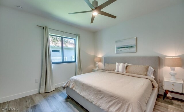 bedroom with ceiling fan and light hardwood / wood-style floors