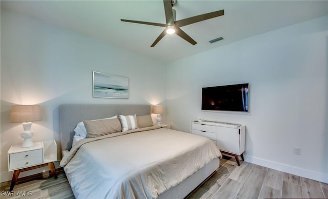 bedroom with light hardwood / wood-style flooring and ceiling fan