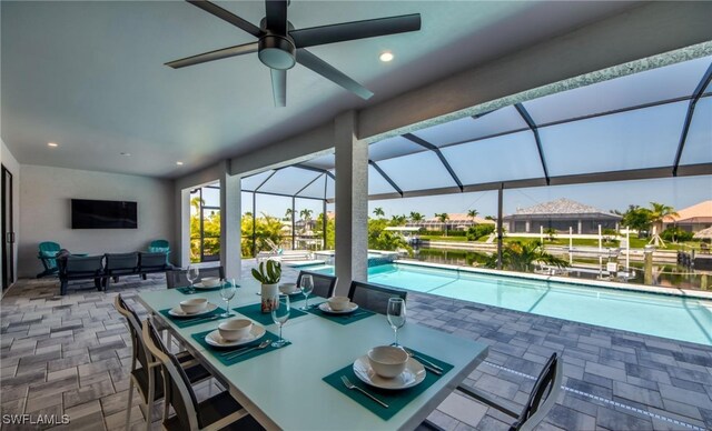 view of swimming pool with a lanai, ceiling fan, and a patio