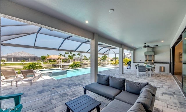 view of swimming pool featuring glass enclosure, ceiling fan, an outdoor living space, an in ground hot tub, and a patio