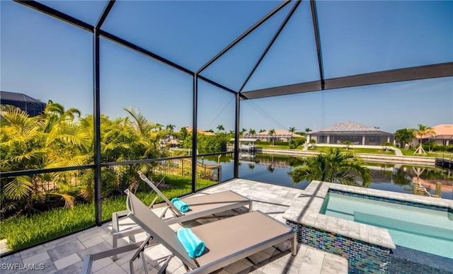 view of patio / terrace featuring an in ground hot tub, a water view, and a lanai