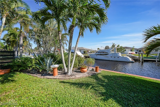 view of yard featuring a boat dock and a water view