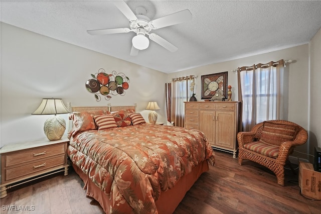 bedroom featuring ceiling fan, dark wood-type flooring, and a textured ceiling