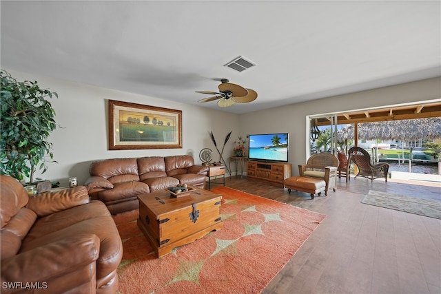 living room with ceiling fan and hardwood / wood-style floors