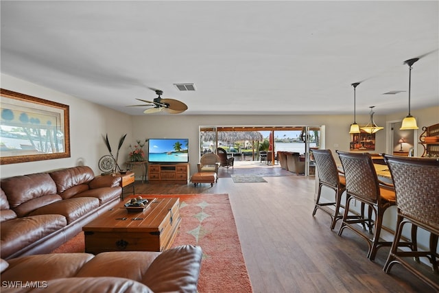 living room featuring dark hardwood / wood-style flooring and ceiling fan