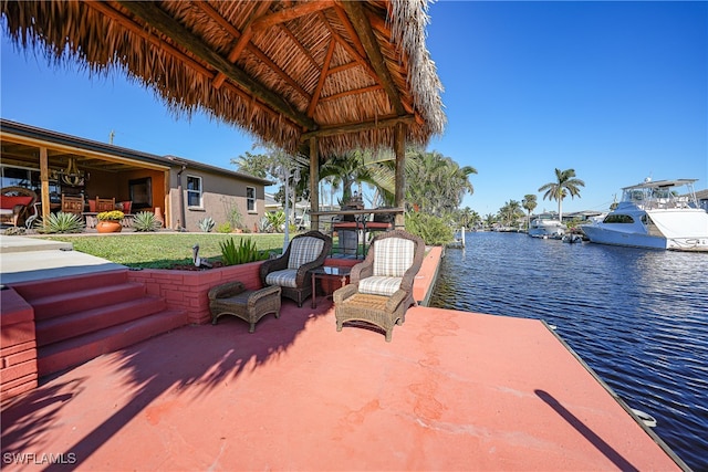 view of patio / terrace with a gazebo and a water view