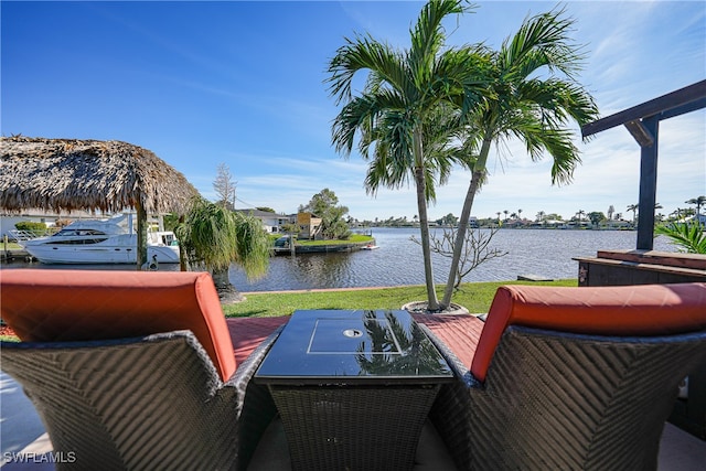 wooden deck featuring a lawn and a water view