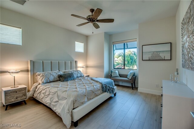 bedroom with light wood-type flooring and ceiling fan