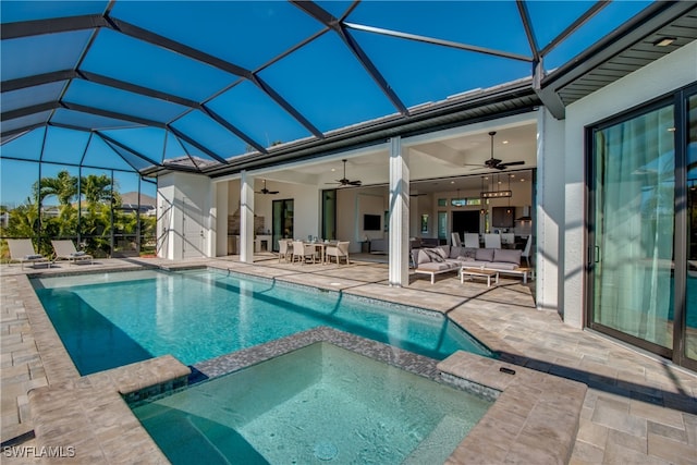 view of swimming pool featuring outdoor lounge area, ceiling fan, a patio area, and glass enclosure