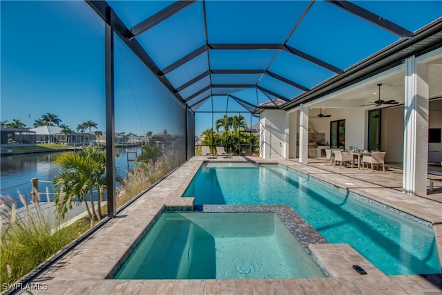 view of pool with a water view, ceiling fan, a lanai, an in ground hot tub, and a patio