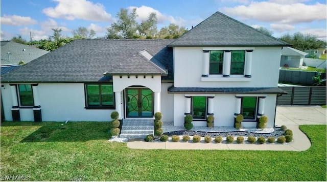 view of front of property featuring a front yard and french doors