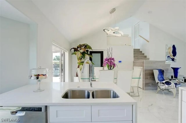 kitchen with white cabinetry, dishwasher, hanging light fixtures, vaulted ceiling, and sink